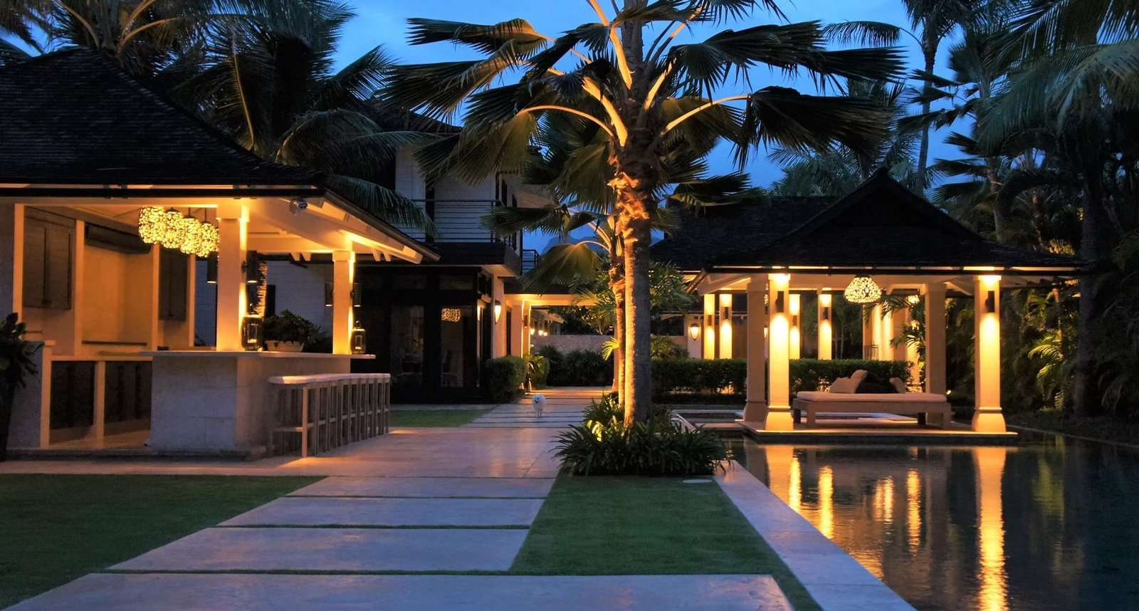 Bronze Age Lighting custom fixtures glowing over a Hawaii residence at dusk